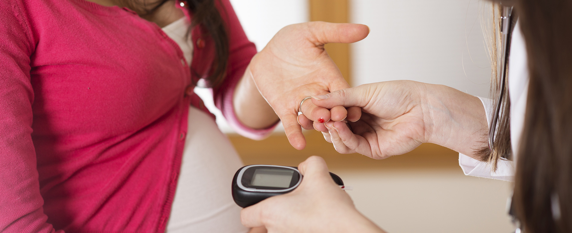 A pregnant patient takes a blood glucose test 