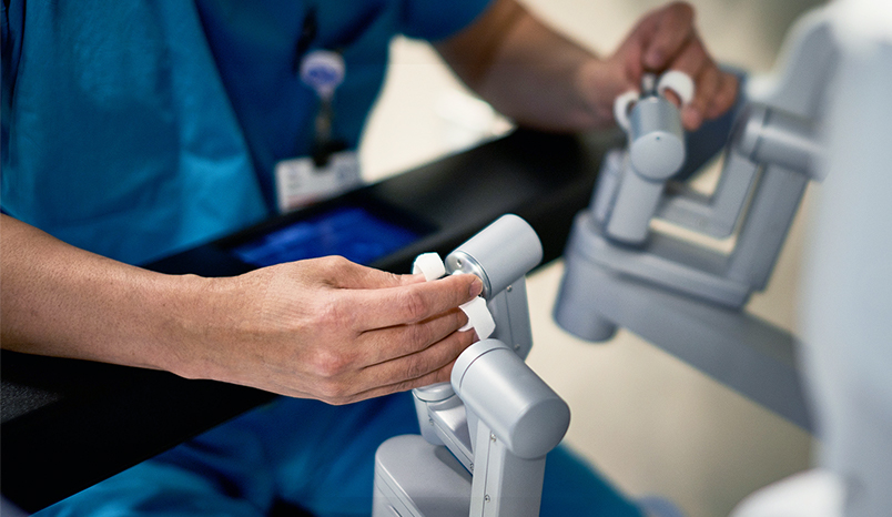 Surgeon operating a robot