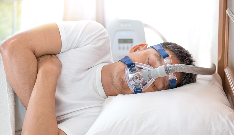 Patient sleeping with apnea mask