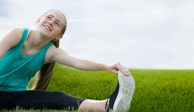 Teen runner stretching 