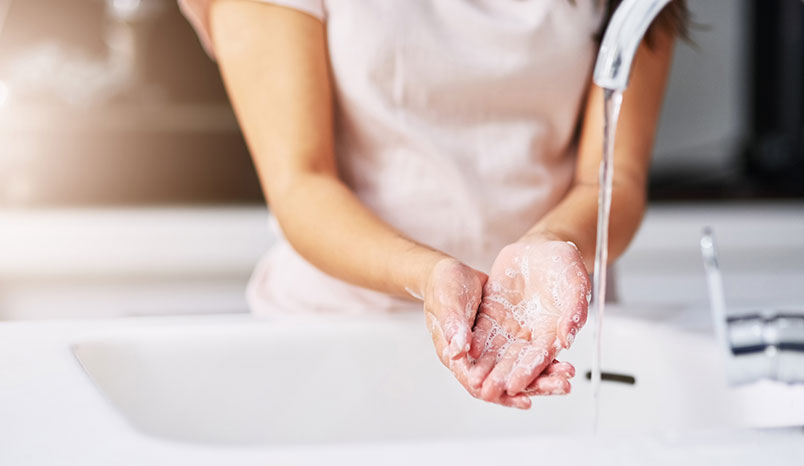 woman-washing-hands-sink