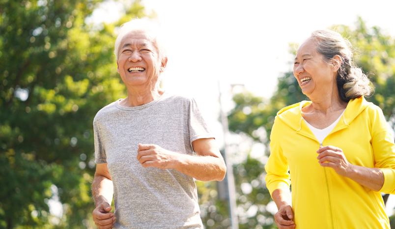 Seniors jogging outside.