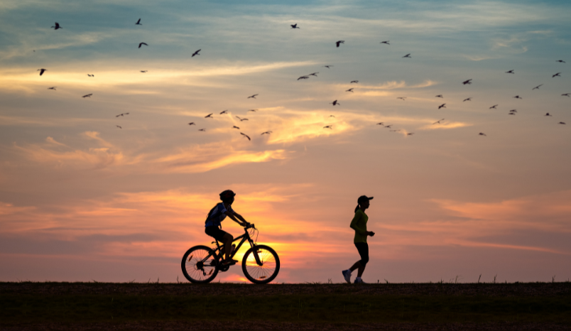 Biker and runner outside.