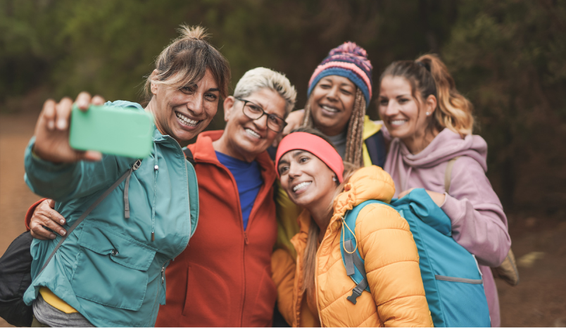 Women on hike stop and pose for a picture.