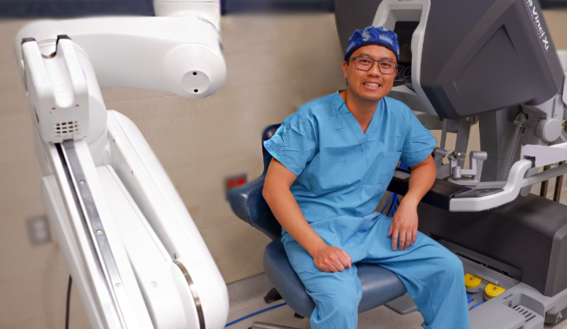 Dr. Pham with robotic surgery equipment.