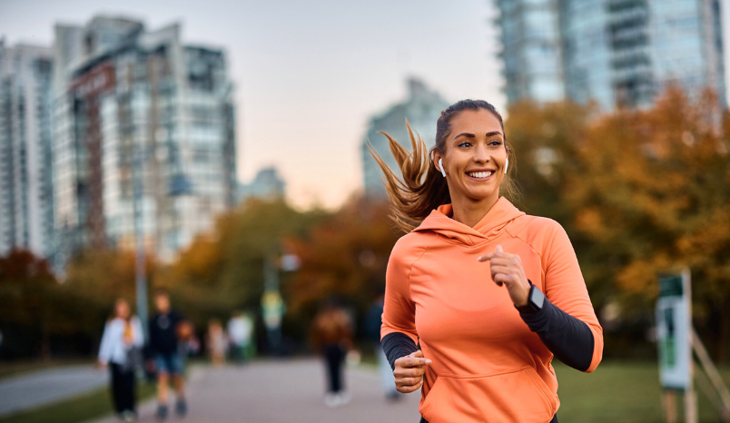 Woman runs outside in city.