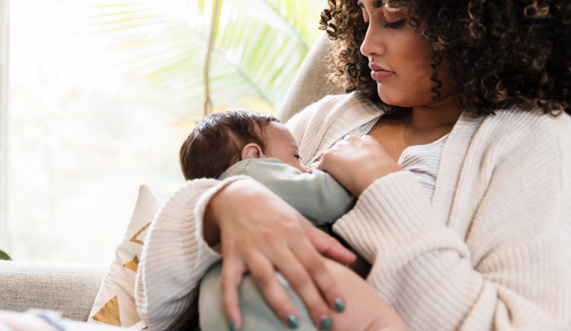 Mother breastfeeds child.