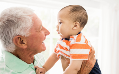 Grandparents holds infant grandchild.