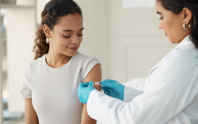 Provider places Band-Aid on patient's arm.