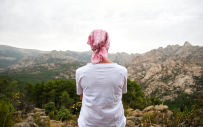 Cancer patient outside looking at mountain landscape.