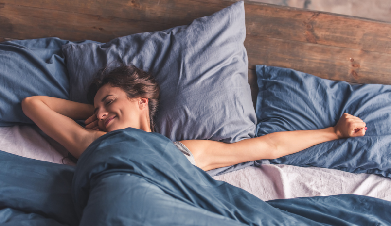 Woman waking up after restful night's sleep.