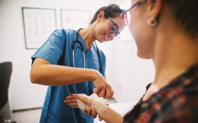 Nurse wraps patient's arm in gauze.