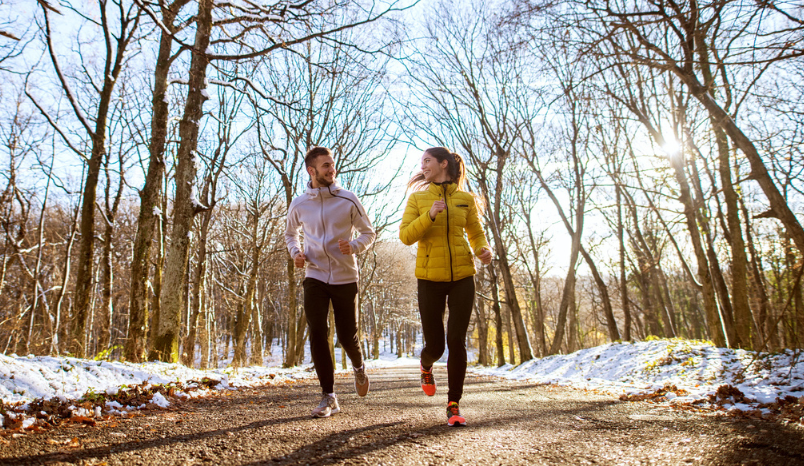 Couple running outside in winter.