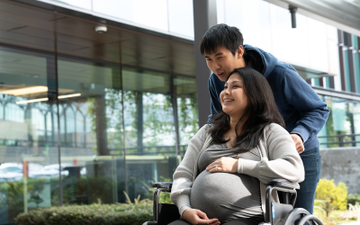 Pregnant woman and husband outside hospital.