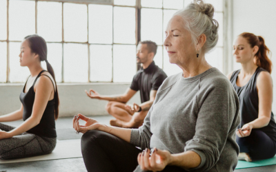 Older adult in yoga class.