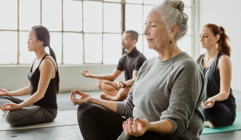 Older adult in yoga class.