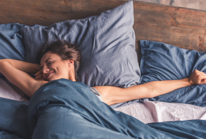 Woman waking up after restful night's sleep.