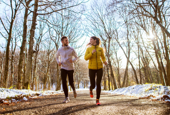 Couple running outside in winter.